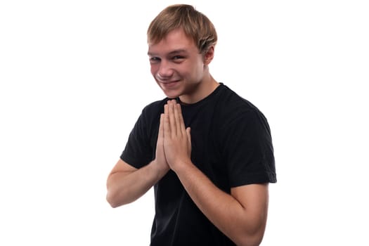 European teenage guy with brown hair smiles while talking.