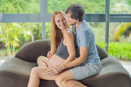 health, pregnancy and happy people concept - husband giving his wife back massage at home.