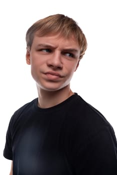 Offended teenage guy with blond hair dressed in a black T-shirt.