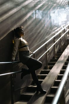 Portrait of a young Asian woman posing in the subway near the stairs