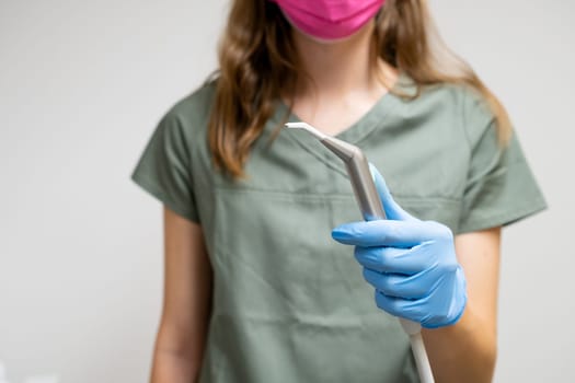 Dental brush in dentist hands in rubber gloves.
