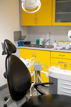 Modern dentist office with black chair.