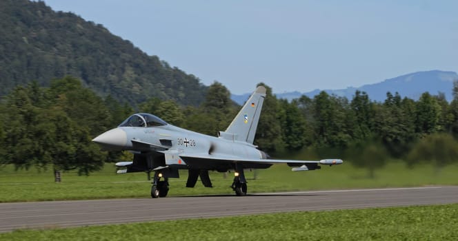 Mollis, Switzerland, August 19, 2023: The German Air Force's Eurofighter Typhoon ascends majestically during a clear day.