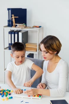 Female psychologist playing games with boy