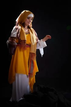 A girl or young woman from ancient Israel, Palestine, Iran, Iraq with a clay jug. A biblical story with Rebekah and water. Stylized photo shoot with a model in Middle Eastern clothes