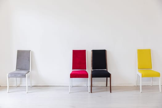 colorful chairs in the interior of a white empty room