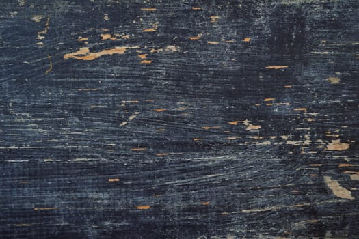 Black paint has peeled off the old wood planks, revealing the light color. High quality photo