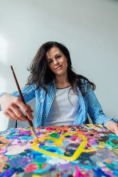 woman artist painting in studio