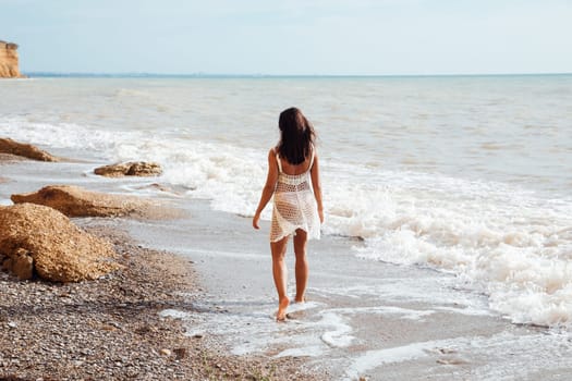 woman walking along the seashore on the beach walking travel