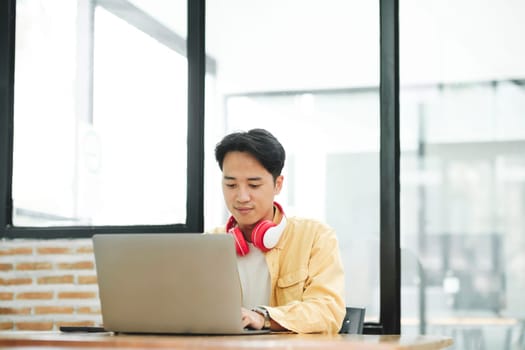 Online education, e-learning. Young collage student using computer and mobile device studying online. Asian young student online learning class study online video call zoom teacher.