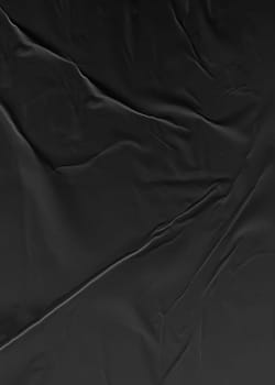 Background texture of crumpled black vertical paper
