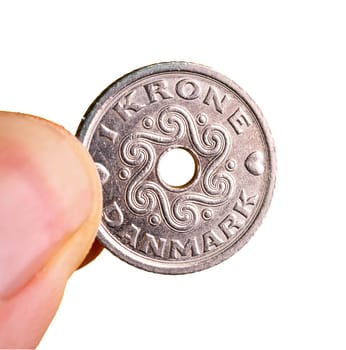 a Danish krone coin between the fingers of the hand with a transparent background