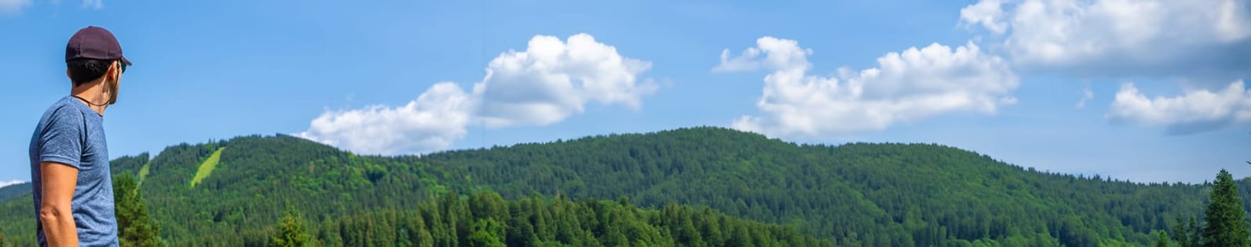 A man in the mountains looks. Selective focus. Selective focus.