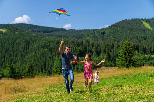 A family flies a kite in nature. Selective focus. Nature.