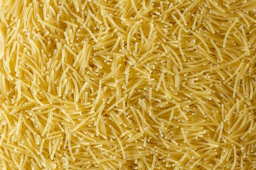 Uncooked Filini Pasta: A Culinary Canvas of Noodles, Creating a Lively and Textured Background for Gourmet Cooking. Dry Pasta. Raw Macaroni - Top View, Flat Lay