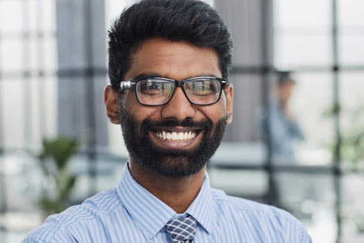 male investor beard looking at camera and smiling in modern office