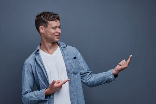 A man on a gray background shows left aside