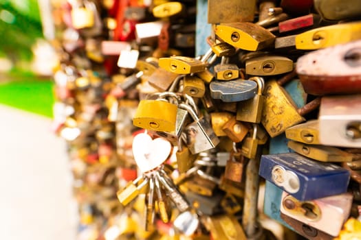 Paris, France - 23 February, 2023: Many wedding locks attached on bridge