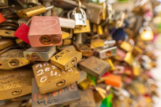 Paris, France - 23 February, 2023: Many wedding locks attached on bridge