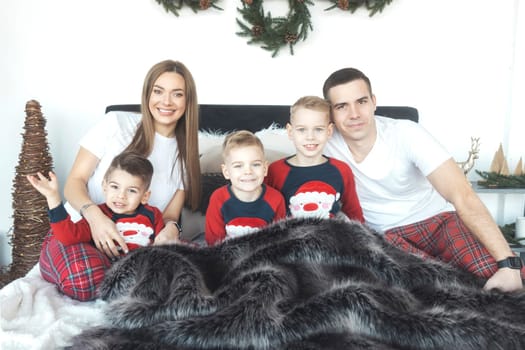 family in the morning waiting for gifts for the New Year , year 2024