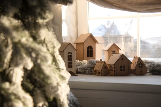 New Year's decorations, snow-covered houses on the windowsill , year 2024