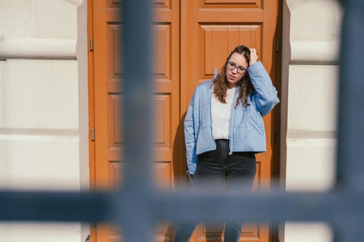 Portrait of a stylish woman in blue jacket. Spring outdoor portrait.