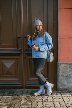 Portrait of a stylish woman in blue jacket. Spring outdoor portrait.