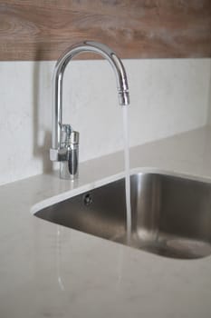 water pouring from a faucet tap slow motion .