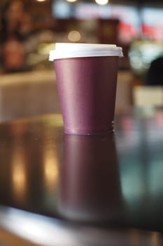 Blank take away kraft coffee cup on table