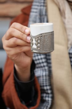 a cup of turkish coffee on table .