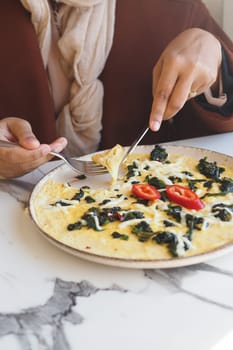 eating Plain Egg Omelette on table .