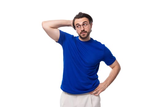 young smart caucasian brunette man with stylish haircut and beard in blue t-shirt thinking about idea and strategy. brainstorm.