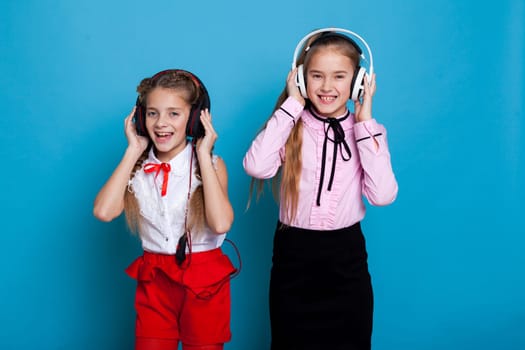 girls listen to dance music in big headphones