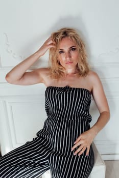Portrait of a beautiful blonde woman in striped pajamas