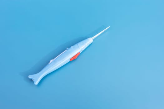 Mockup Flatly Ear Wax Removal Stick with Light Or Curette on Blue Background, Copy Space For text. Closeup Auricle and Inner Ear Tool Cleaner. Personal Care Hygiene Essentials. Horizontal Plane