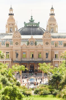 Monaco, Monte-Carlo, 21 October 2022 - Square Casino Monte-Carlo at sunny day, wealth life, tourists take pictures of the landmark, pine trees, blue sky. High quality photo