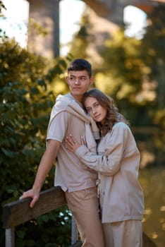 Young Cute Female Hugs Boyfriend. In Autumn Outdoor. Lovers Walking in Park. Attractive Funny Couple. Lovestory in Forest. Man and Woman. Cute Lovers in the Park. Family Concept. Happy Couple.