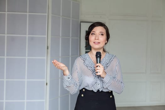 beautiful Asian woman with a microphone in her hands