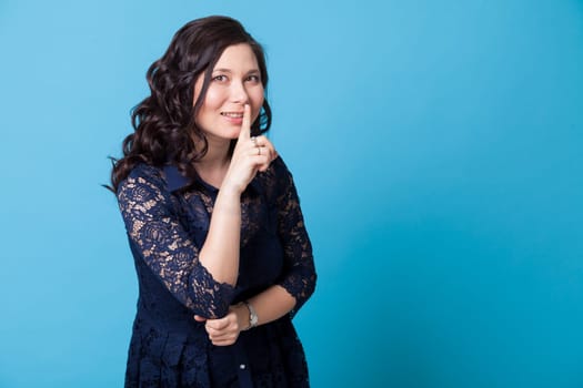 Portrait of a Asian woman in a blue dress shows 1 finger