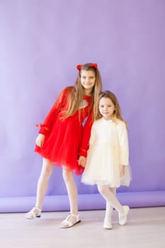 Two beautiful girls in red and white dresses for the holiday