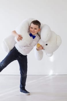 Beautiful boy with toy big teddy bear