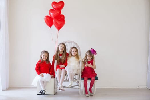 Girls with red heart-shaped balloons on birthday