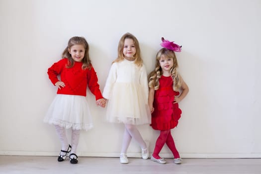 three girls in red and white dresses for the holiday
