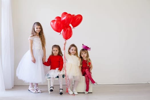 Girls with red heart-shaped balloons on birthday