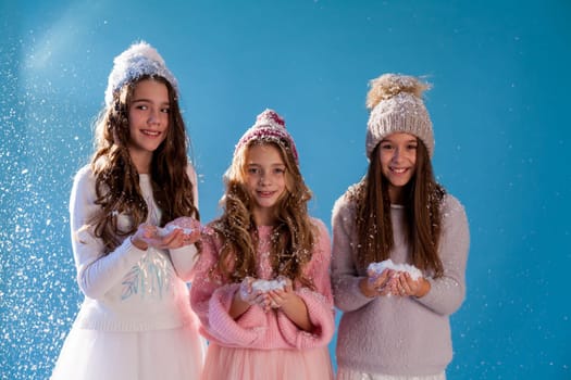 Three beautiful girls in winter snow caps