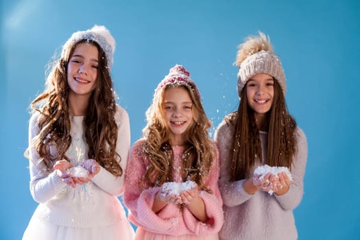 Three beautiful girls in winter snow caps