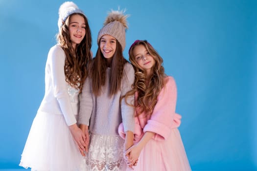 Three beautiful girls in winter snow caps