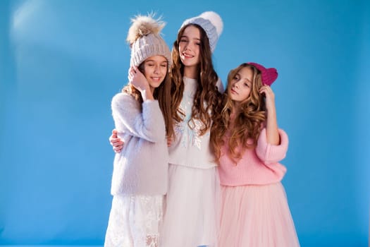 Three beautiful girls in winter snow caps