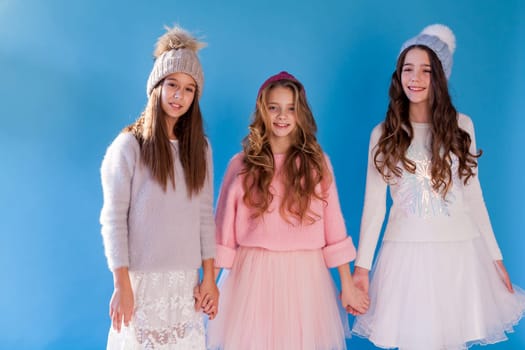 Three beautiful girls in winter snow caps