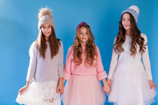 Three beautiful girls in winter snow caps